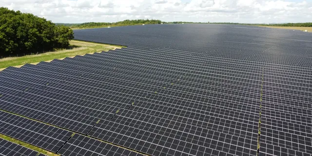 Es werden auf einem Feld nahe der Stadt Troyes in Frankreich großflächige Solarpanels mit darunter liegenden Weideflächen dargestellt.